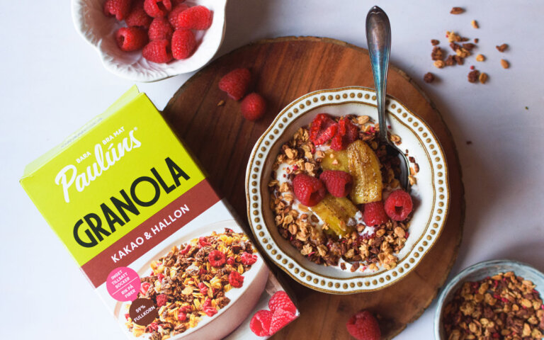 Skål med yoghurt och Pauluns granola med karamelliserad banan och hallon.